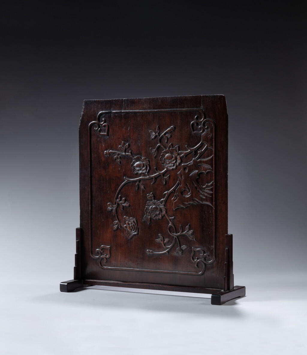 View full screen - View 1 of Lot 156. A carved zitan archaistic 'chilong and peony' panel, Qing dynasty, 18th century | 清十八世紀 紫檀雕螭龍牡丹紋板.
