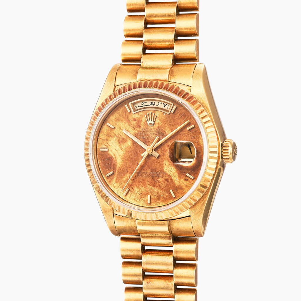 View full screen - View 1 of Lot 140. Day-Date, Reference 18038 | A yellow gold wristwatch with day, date, bracelet and birch burl wood dial with Arabic calendar | Circa 1980 .