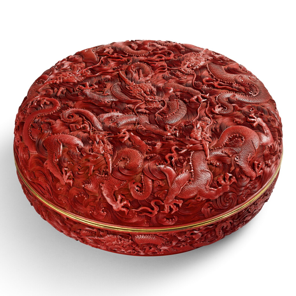 View full screen - View 1 of Lot 3660. A LARGE CARVED CINNABAR LACQUER 'DRAGON' BOX AND COVER QING DYNASTY, QIANLONG PERIOD | 清乾隆 剔紅海水雲龍紋圓蓋盒.