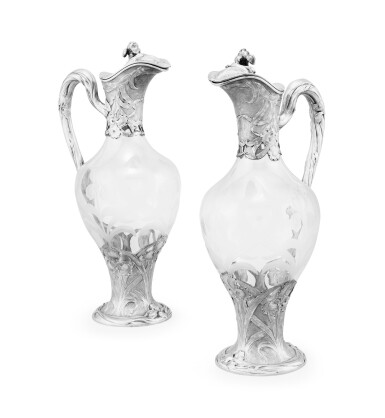 View full screen - View 1 of Lot 241. A pair of cut-glass ewers with silver mounts decorated with iris, Puiforcat, Paris, circa 1900 | Paire d’aiguières en verre montées en argent à décor d’iris par Puiforcat, Paris, vers 1900.