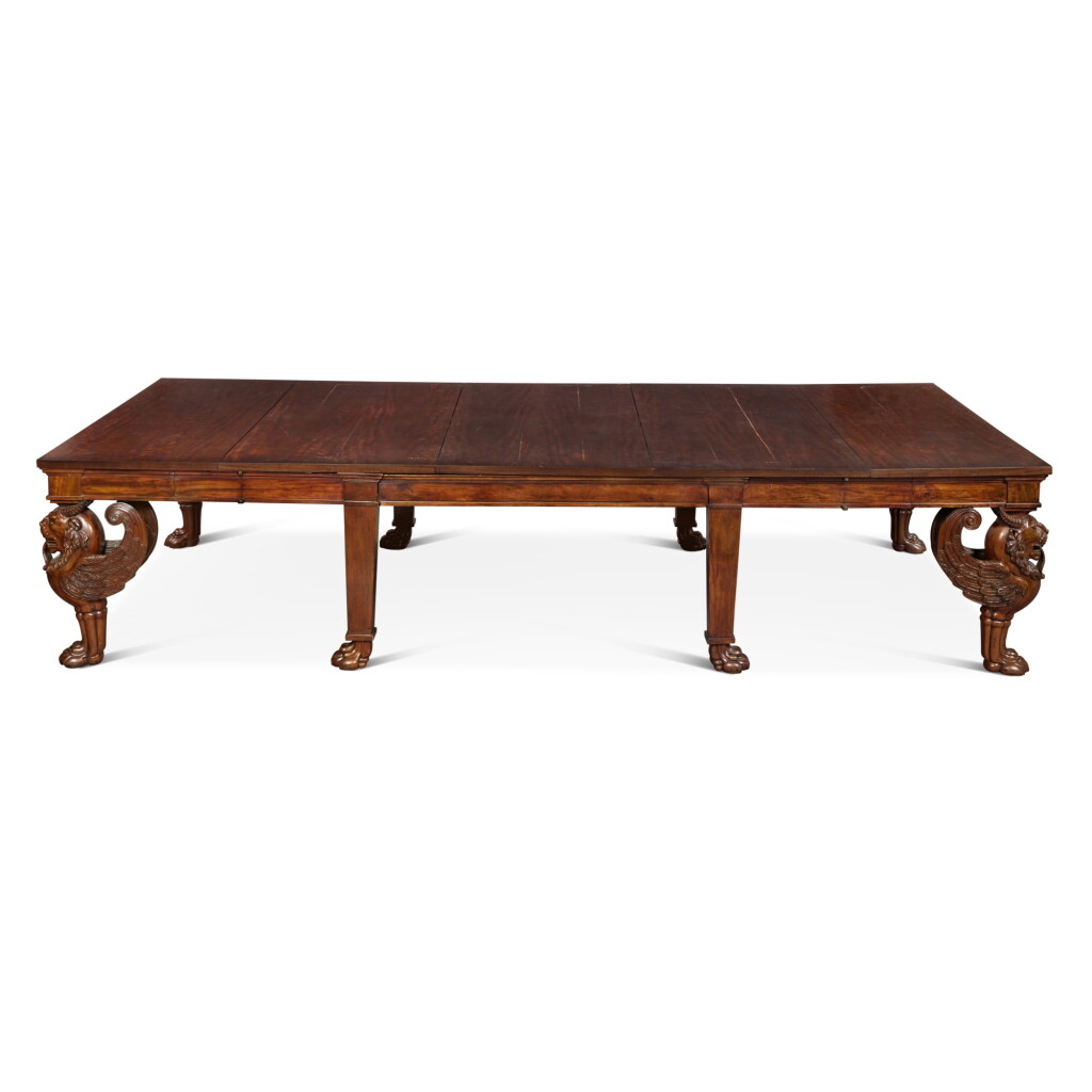 View full screen - View 1 of Lot 69. An English Mahogany Concertina-Action Extending Dining Table, 19th Century and Later, with Four Additional Later Leaves.