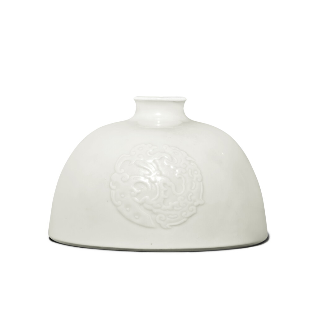 View full screen - View 1 of Lot 212. A molded white-glazed ‘kuilong’ beehive waterpot (Taibaizun), Mark and period of Kangxi .