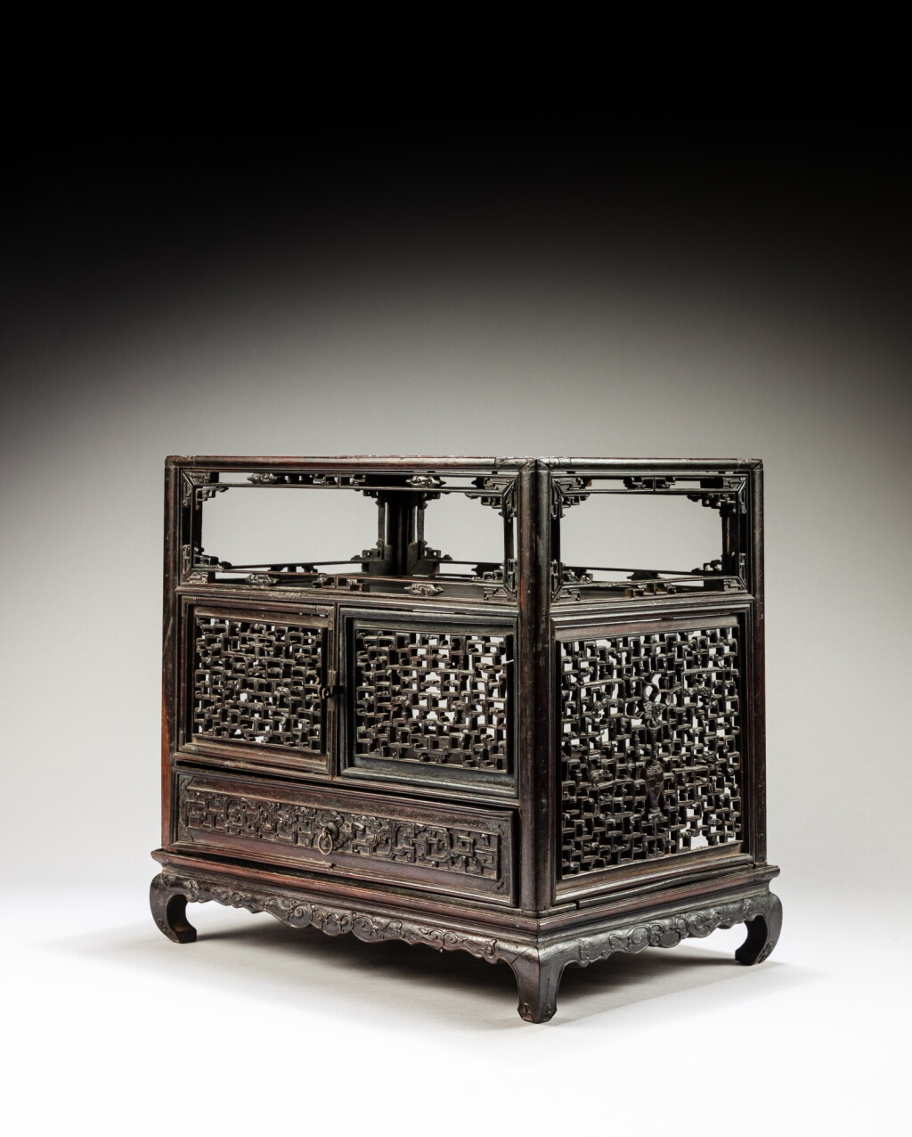 View full screen - View 1 of Lot 151. A 'hongmu' reticulated archaistic table cabinet, Qing dynasty, late 18th - early 19th century | 清十八世紀末至十九世紀初 紅木鏤雕仿古官皮箱 .