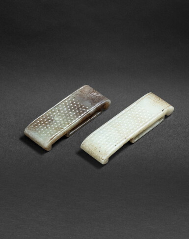 View full screen - View 1 of Lot 164. Deux ornements de sabre en jade sculpté céladon et brun, wei Dynastie Qing ou antérieure | 清或更早期 青白玉帶飾一組兩件 | Two archaistic celadon jade scabbard slides, wei, Qing Dynasty or earlier.