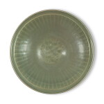 A large molded 'Longquan' celadon-glazed dish, Ming dynasty | 明 龍泉窰青釉印花大盤