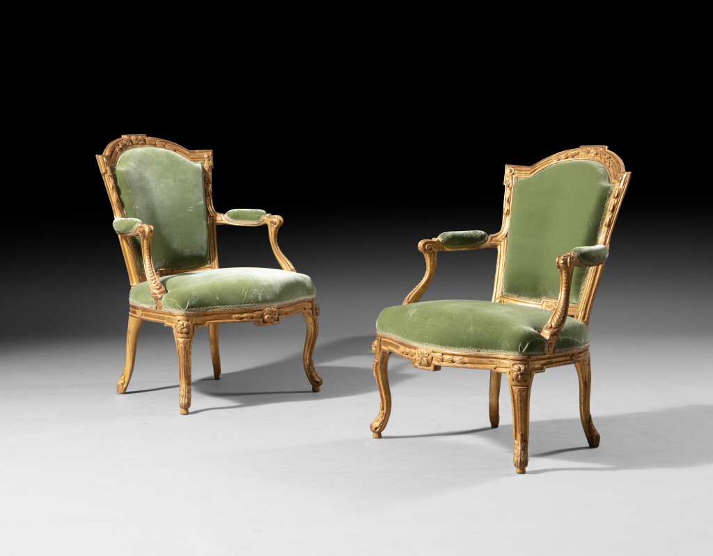 View full screen - View 1 of Lot 33. A pair of giltwood armchairs, Louis XV, stamp by Jacques-Jean-Baptiste Tilliard | Paire de fauteuils en hêtre redoré d'époque Louis XV, vers 1750, estampille de Jacques-Jean-Baptiste Tilliard.