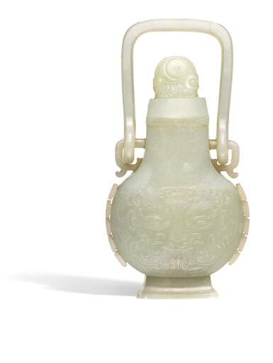 View full screen - View 1 of Lot 119. A CELADON JADE ARCHAISTIC HANGING VASE AND COVER QING DYNASTY, 18TH CENTURY | 清十八世紀 青白玉仿古饕餮紋提樑卣.