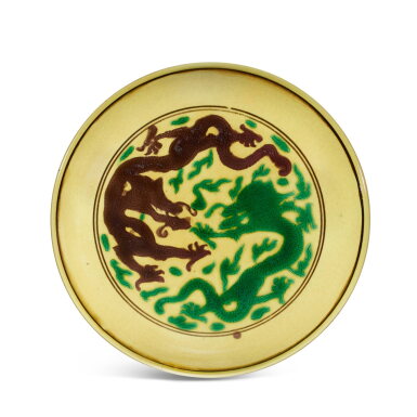 View full screen - View 1 of Lot 502. A yellow-ground green and aubergine-enamelled 'dragon' dish, Mark and period of Kangxi 清康熙 黃地紫綠彩葡萄雲龍紋盤 《大清康熙年製》款.