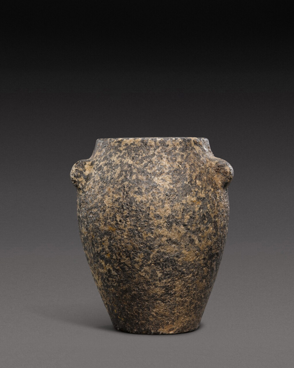 View full screen - View 1 of Lot 120. An Egyptian Breccia or Diorite Jar, late Predynastic Period/1st Dynasty, circa 3100-2815 B.C..