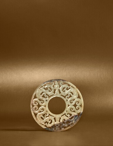 View full screen - View 1 of Lot 111. A rare carved and reticulated jade 'dragon and human' disc (Bi), Eastern Zhou dynasty, Warring States period.