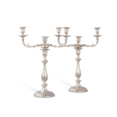 View full screen - View 1 of Lot 93. A matched pair of large George III silver three-light candelabra, one John Scofield, London, 1791, the other Richard Cook, London, 1807 | Deux grands candélabres à trois lumières en argent formant paire, l’un par John Scofield, Londres, 1791 et l’autre par Richard Cook, Londres, 1807.