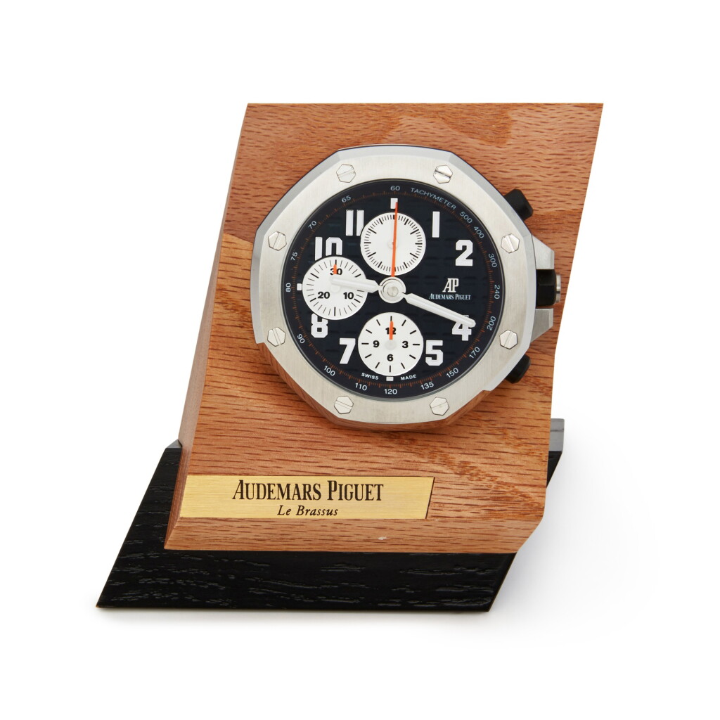 View full screen - View 1 of Lot 289. Royal Oak Offshore | A stainless steel alarm desk timepiece with wooden stand, Circa 2019.