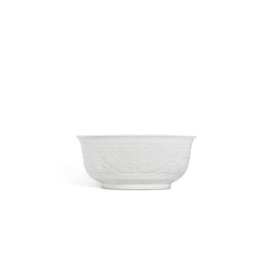 View full screen - View 1 of Lot 5868. A white-glazed moulded 'phoenix' bowl, Mark and period of Yongzheng | 清雍正 白釉仿古夔凤紋盌 《大清雍正年製》款.