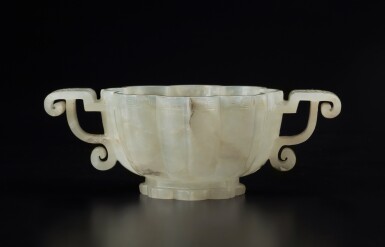 View full screen - View 1 of Lot 51. A pale celadon jade lobed cup, Ming dynasty | 明 青白玉菱花式雙耳盃.