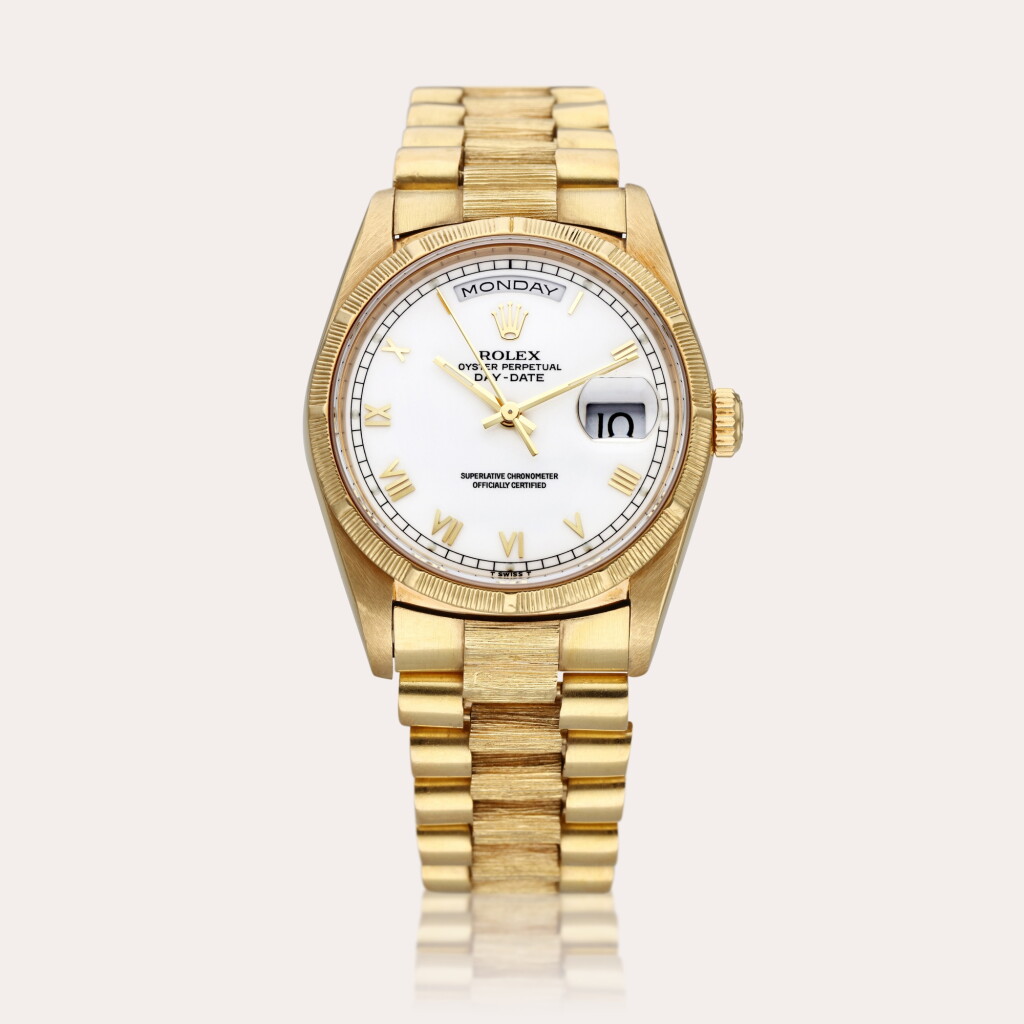 View full screen - View 1 of Lot 310. Reference 18248 Day-Date ‘Bark’ | A yellow gold automatic wristwatch with day, date, and bark finish bezel and bracelet, Circa 1988.