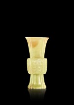 A small yellow and russet jade 'taotie' gu vase, Qing dynasty, Qianlong period | 清乾隆 黃玉仿古饕餮紋海棠式花觚