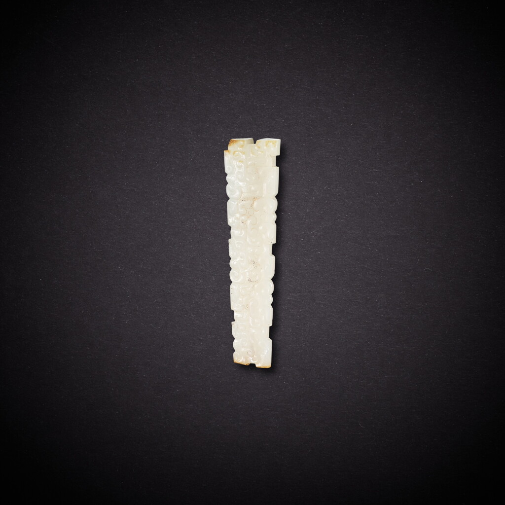 View full screen - View 1 of Lot 7840. A white and russet jade 'dragon' pendant, Eastern Zhou dynasty | 東周 白玉龍紋珮.