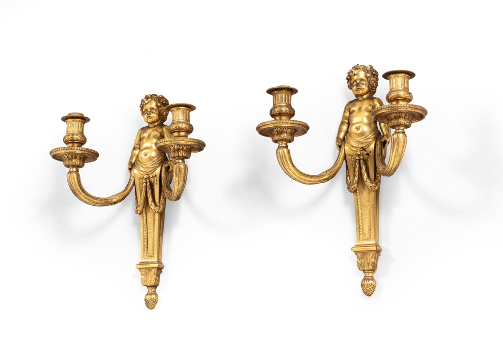 View full screen - View 1 of Lot 120. A pair of Louis XVI gilt-bronze wall appliques, attributed to Pierre Gouthière after a design by Jean-Louis Prieur, circa 1780 | Paire d'appliques aux enfants en bronze ciselé et doré d'époque Louis XVI, attribuées à Pierre Gouthière, vers 1780.