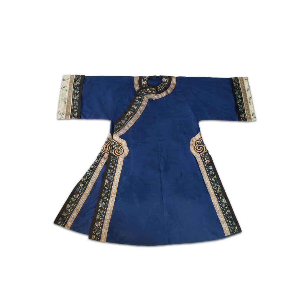 View full screen - View 1 of Lot 943. A blue-ground gauze 'dragon' lady's robe, Late Qing dynasty | 清末 藍地納紗暗花團龍紋氅衣 .