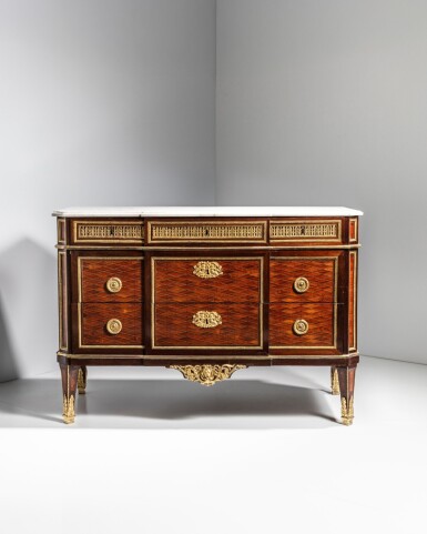 View full screen - View 1 of Lot 21. A Louis XVI gilt-bronze mounted tulipwood, amaranth, holywood mosaic-shaped marquetry commode, circa 1780-1785, stamped by Jean-Henri Riesener.