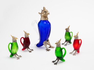 View full screen - View 1 of Lot 348. A Spanish group of six colored glass decanters the largest representing a cockatoo and the five small ones a lapwing, 20th century | Groupe de six carafes en verre de couleur représentant la plus grande en forme de cacatoès, les cinq petites en forme de vanneaux, les montures en argent et métal-argenté, Espagne, XXème siècle.