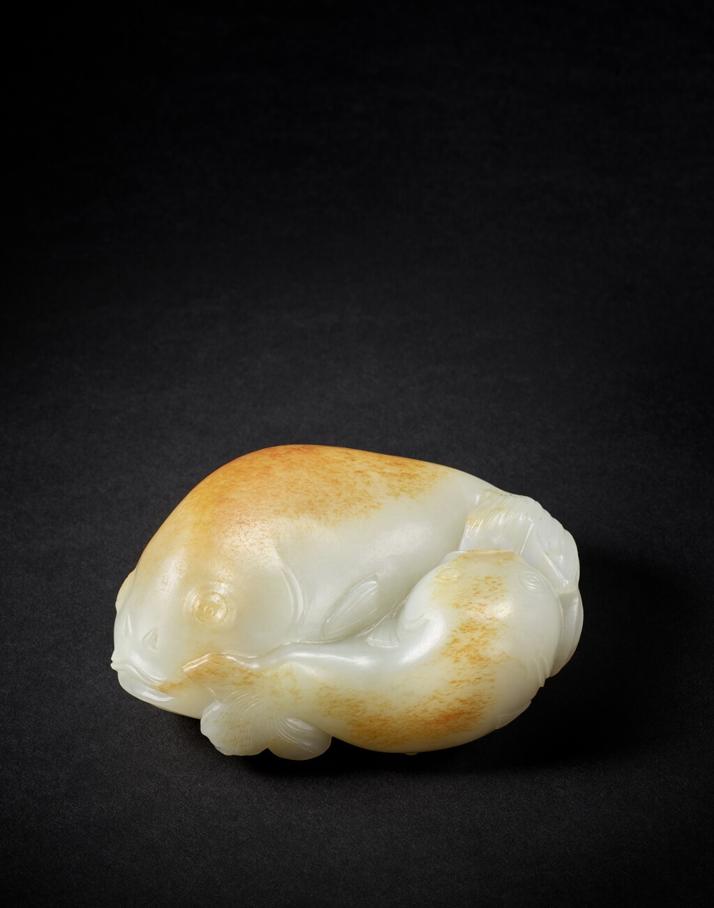View full screen - View 1 of Lot 9854. A white and russet jade twin fish, Qing dynasty, 18th century | 清十八世紀 白玉圓雕雙魚.
