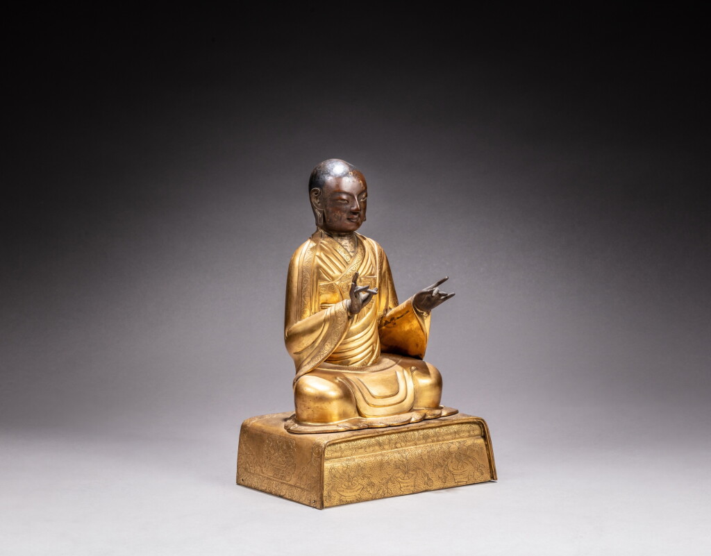 View full screen - View 1 of Lot 23. A gilt-copper repoussé and gilt-copper alloy figure of an Arhat, Qing dynasty, 18th century.