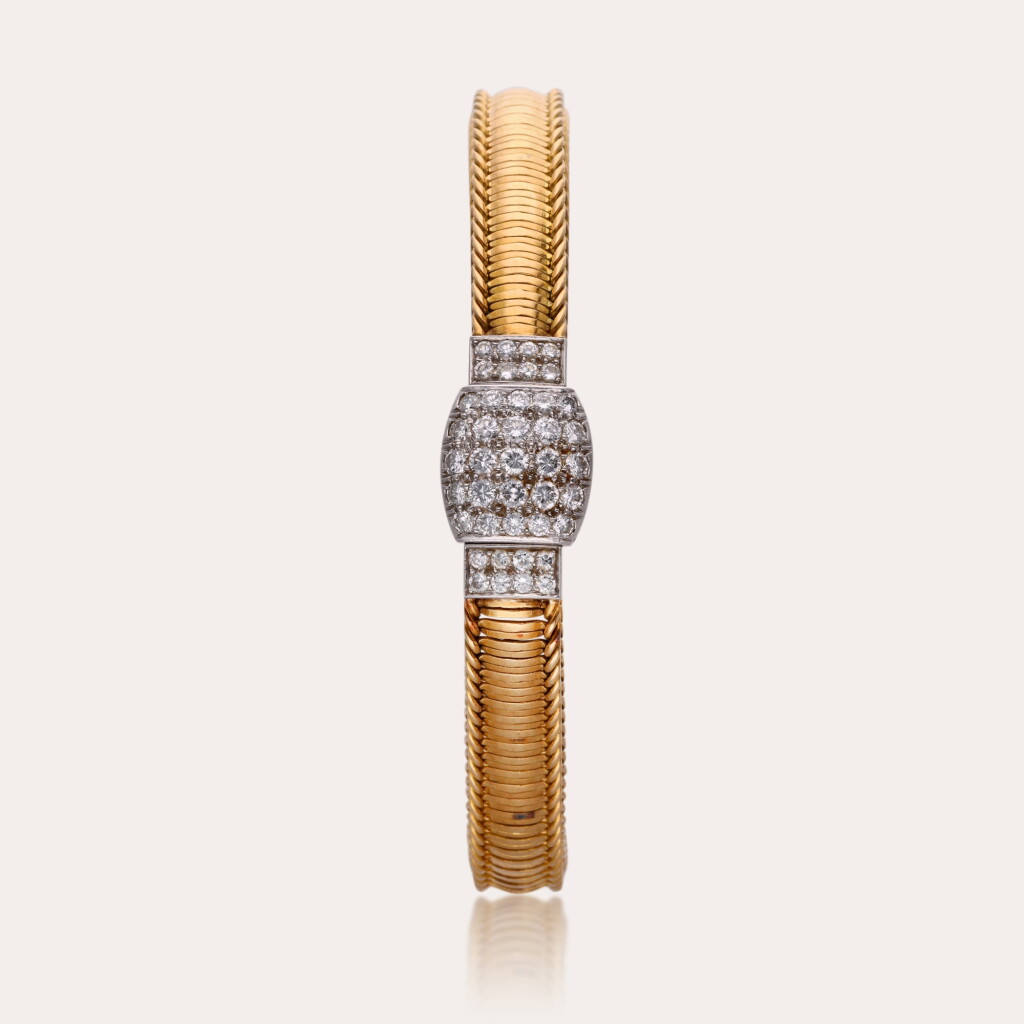 View full screen - View 1 of Lot 457. Reference 6924 | Retailed by Cartier: A yellow gold and diamond-set concealed bracelet watch, Circa 1980.