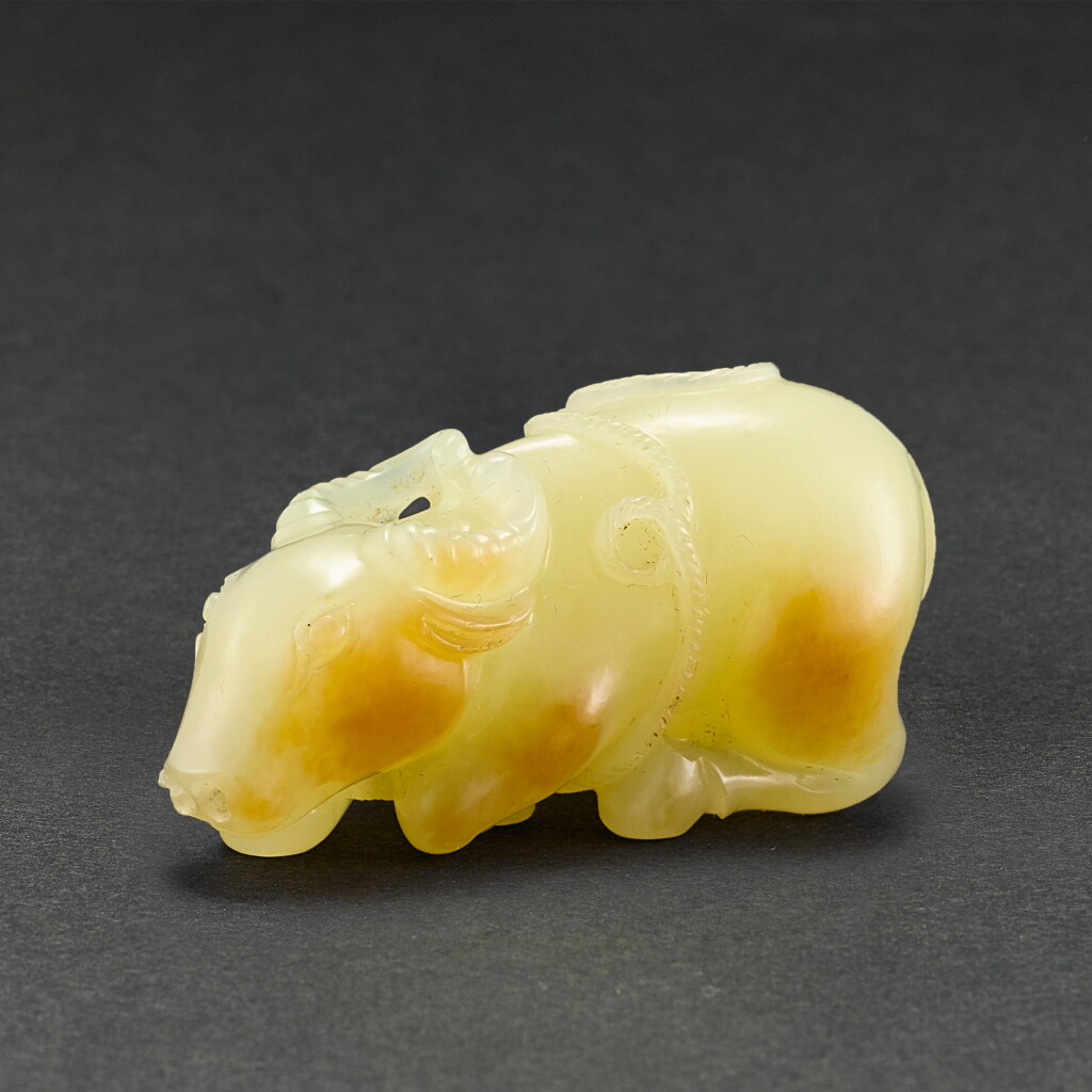 View full screen - View 1 of Lot 555. A YELLOW JADE FIGURE OF A BUFFALO QING DYNASTY | 清 黃玉臥牛.