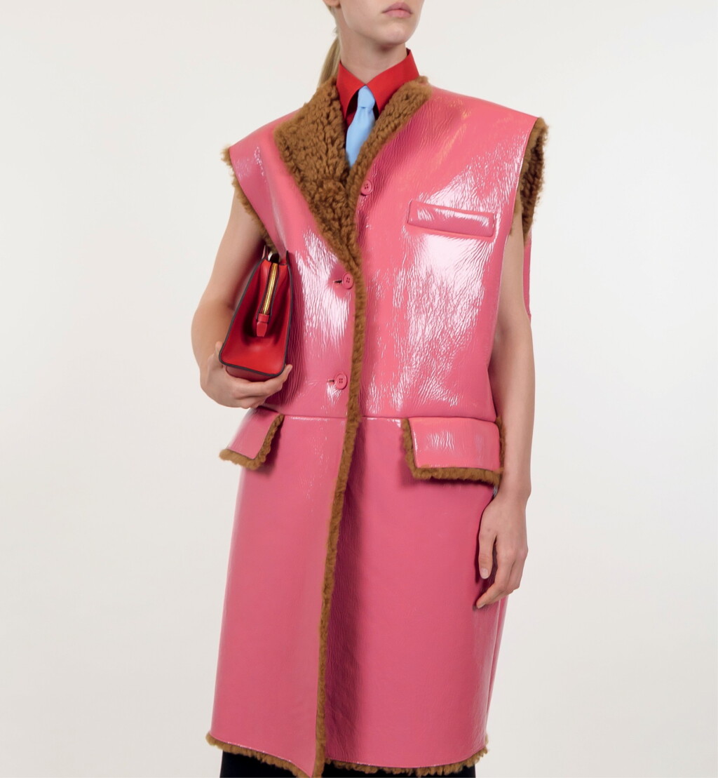 View full screen - View 1 of Lot 32. PRADA | PINK PATENT SHEARLING SLEEVELESS COAT, WOOL SKIRT, ORGANZA STRETCH SHIRT, POPLIN TIE. UNIQUE READY-TO-WEAR NOT IN THE STORES.