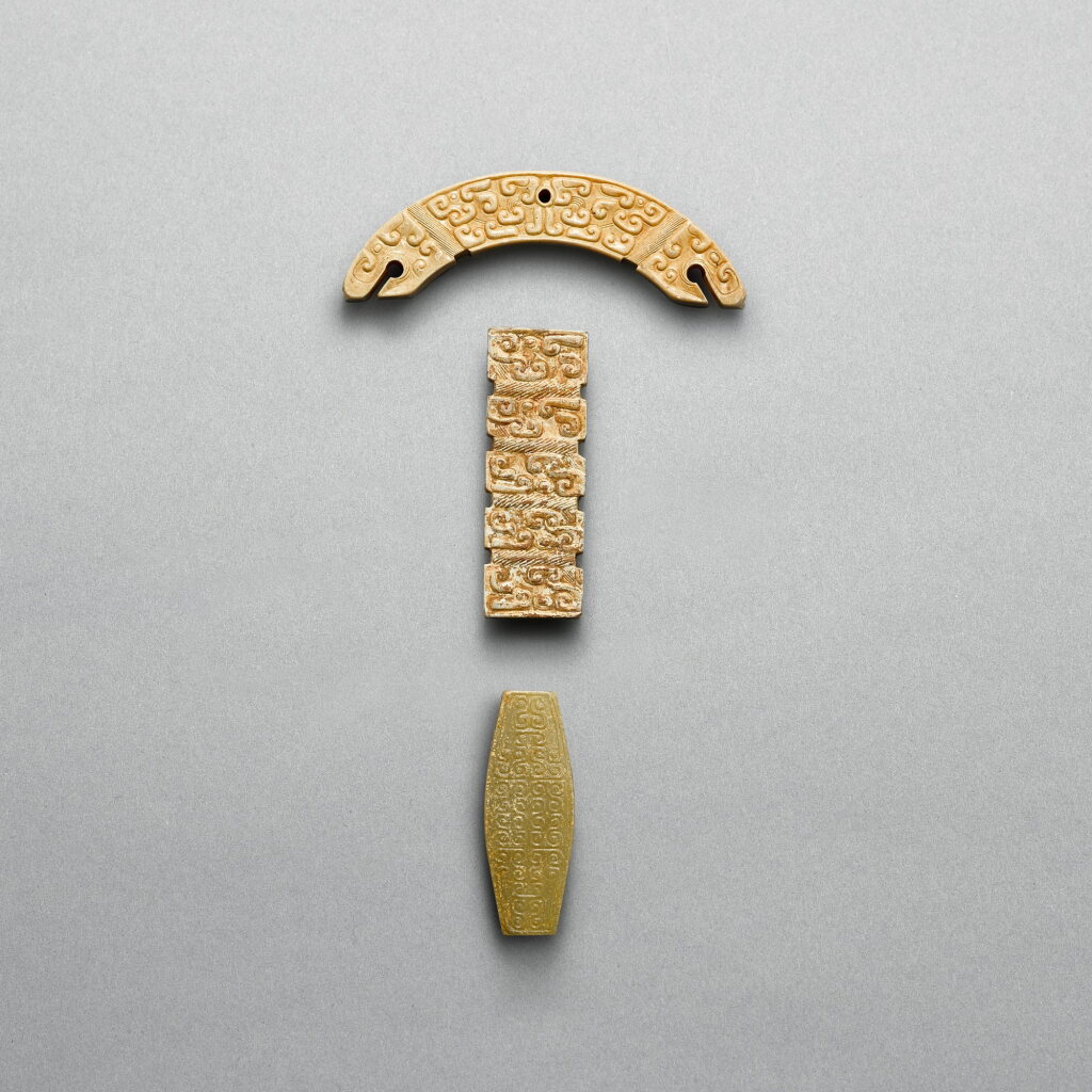View full screen - View 1 of Lot 739. Two jade 'dragon' pendants and a celadon jade 'cloud' bead, Eastern Zhou dynasty or later | 東周或更晚 龍紋玉璜一件、夔紋長方玉管一件 及 卷雲紋紡錐形玉管一件.