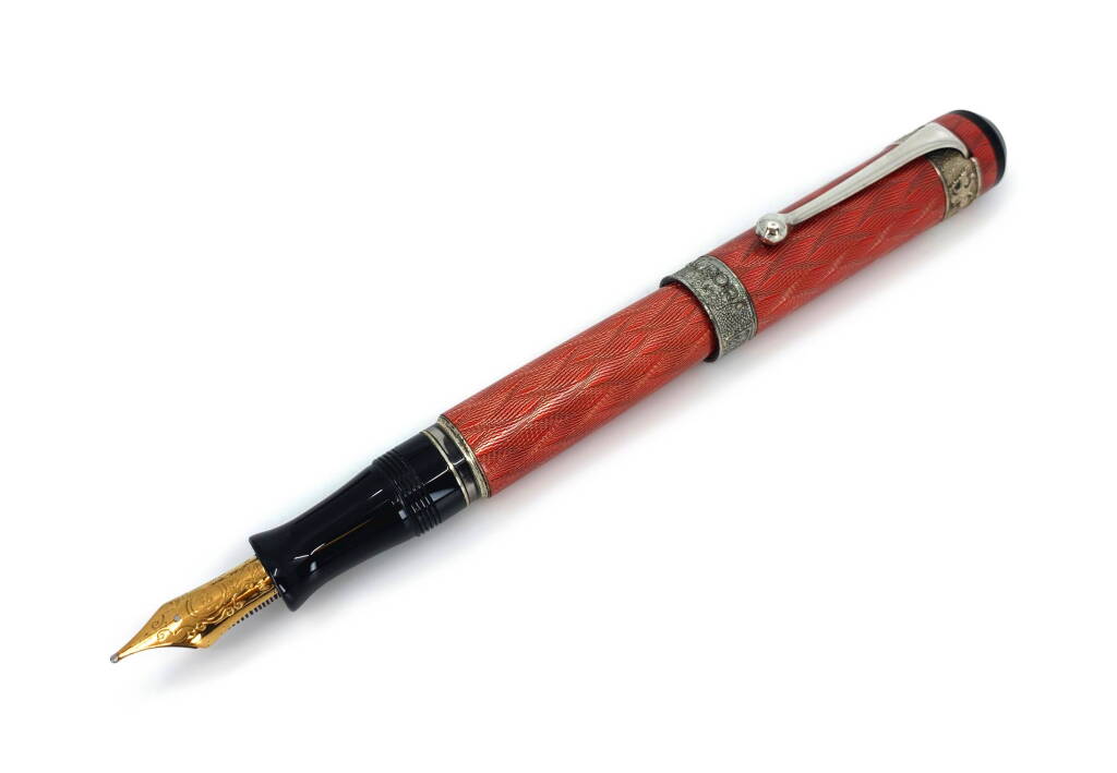 View full screen - View 1 of Lot 129. AURORA | A STERLING SILVER GUILLOCHE WITH RED ENAMEL FOUNTAIN PEN, CIRCA 2003.