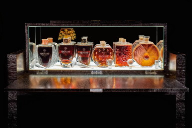 View full screen - View 1 of Lot 178. THE MACALLAN IN LALIQUE SIX PILLARS COLLECTION WITH BLACK LACQUER WALNUT CABINET BY JAMES LAYCOCK.