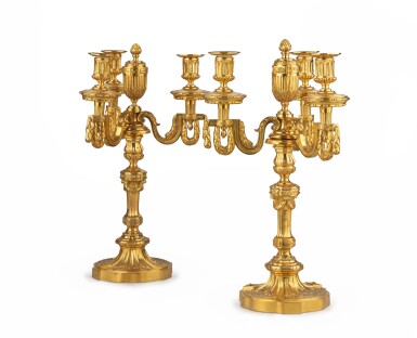 View full screen - View 1 of Lot 34. A pair of Louis XVI style gilt bronze four-light candelabra | Paire de candélabres à quatre lumières en bronze doré, de style Louis XVI,.