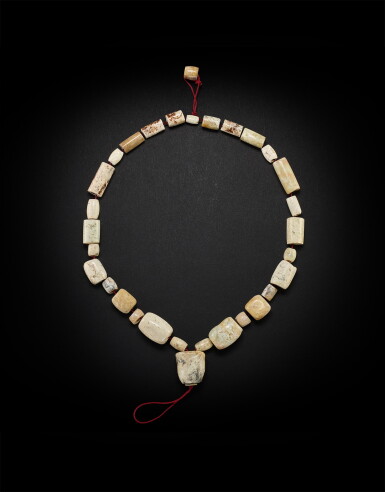 View full screen - View 1 of Lot 3787. A calcified jade bead necklace, Neolithic period, Liangzhu culture or middle Yangzi region, 4th - 3rd millennium BC | 新石器時代 良渚或長江中游文化 公元前四千至三千年 玉管項飾.