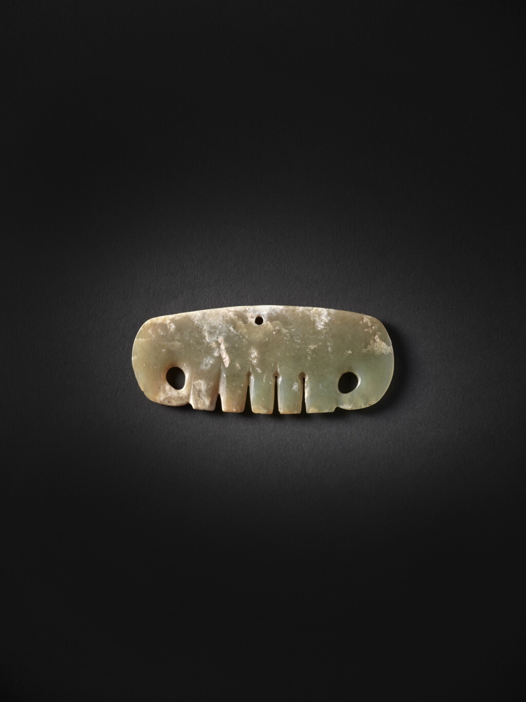 View full screen - View 1 of Lot 244. An archaic celadon jade cloud-shaped pendant, Neolithic period, Hongshan culture | 新石器時代 紅山文化 玉雲形珮.