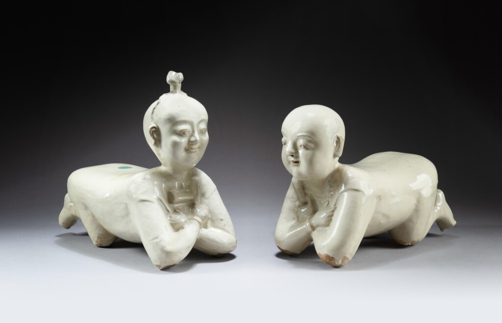 View full screen - View 1 of Lot 163. Two cream-glazed 'lying child' pillows Qing dynasty | 清 白釉嬰兒枕兩件.