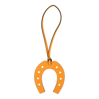 View full screen - View 1 of Lot 133. Hermès Paddock Jaune D'or Horseshoe Bag Charm of Swift Leather PM.