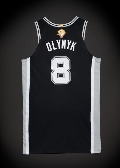 View full screen - View 1 of Lot 30. Kelly Olynyk San Antonio Spurs 2026 NBA Finals Game Issued Icon Edition Jersey | Game 1 | Matched to Game 1 Locker Room Image.