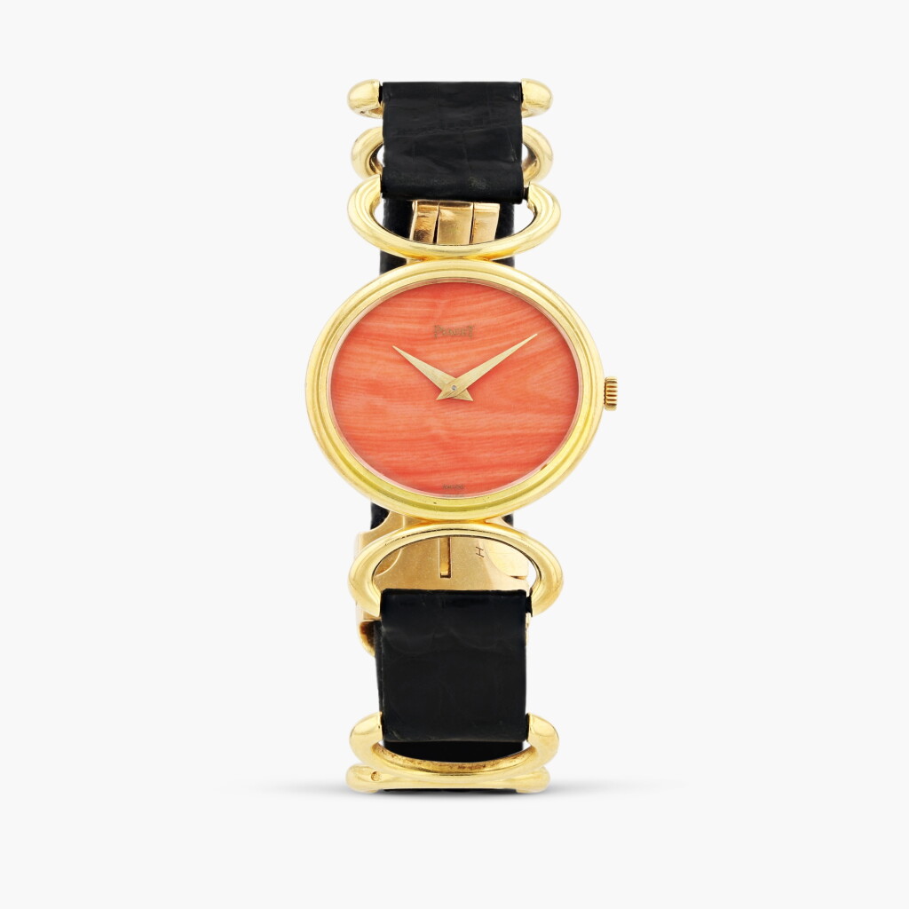 View full screen - View 1 of Lot 421. Reference 9802 D, yellow gold wristwatch with coral dial, circa 1970.