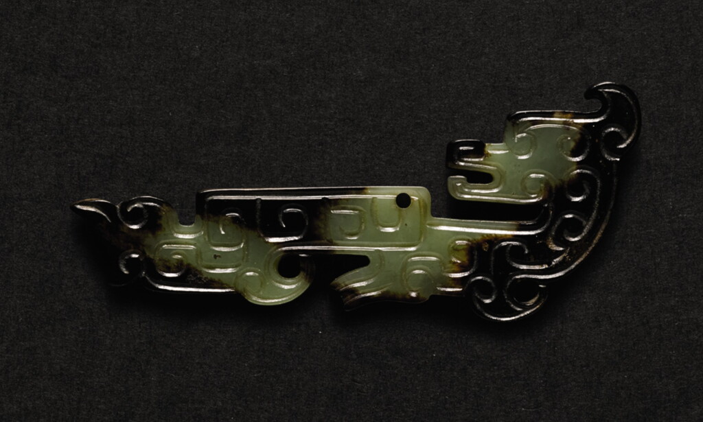 View full screen - View 1 of Lot 227. A SMALL CELADON AND BROWN JADE 'DRAGON' FRAGMENT SHANG DYNASTY - WESTERN ZHOU DYNASTY | 商至西周 褐斑青玉龍紋珮.