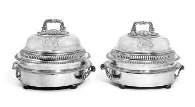 View full screen - View 1 of Lot 115. A Pair of George III Silver Serving Dishes with Domed Covers and Sheffield plate heated bases, the dishes Thomas Heming, London, 1774, the covers Samuel Hennell & John Terrey, London, 1815.