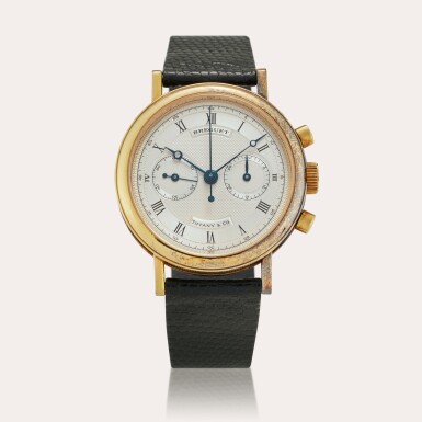 View full screen - View 1 of Lot 142. Reference 3230 Classique Chronograph | Retailed by Tiffany & Co.: A yellow gold chronograph wristwatch, Circa 1984.