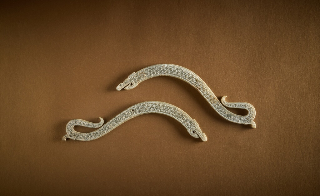 View full screen - View 1 of Lot 114. A pair of jade 'dragon' pendants, Eastern Zhou dynasty, Warring States period .