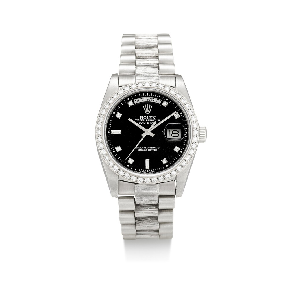 View full screen - View 1 of Lot 1107. ROLEX | DAY-DATE, REFERENCE 1803, A WHITE GOLD AND DIAMOND-SET WRISTWATCH WITH DAY, DATE, BRACELET AND LATER RODIUM-PLATED BEZEL, CIRCA 1982.