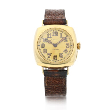 View full screen - View 1 of Lot 70. Retailed by Tiffany & Co.: A yellow gold cushion shaped wristwatch, Made in 1908.