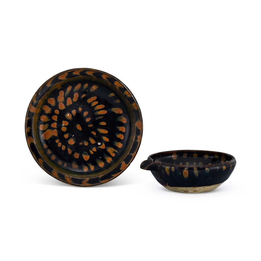 View full screen - View 1 of Lot 364. A russet-splashed black-glazed dish and pouring vessel, yi, Song - Yuan dynasty 宋至元 黑釉鏽斑折沿盤 及 匜一組兩件.
