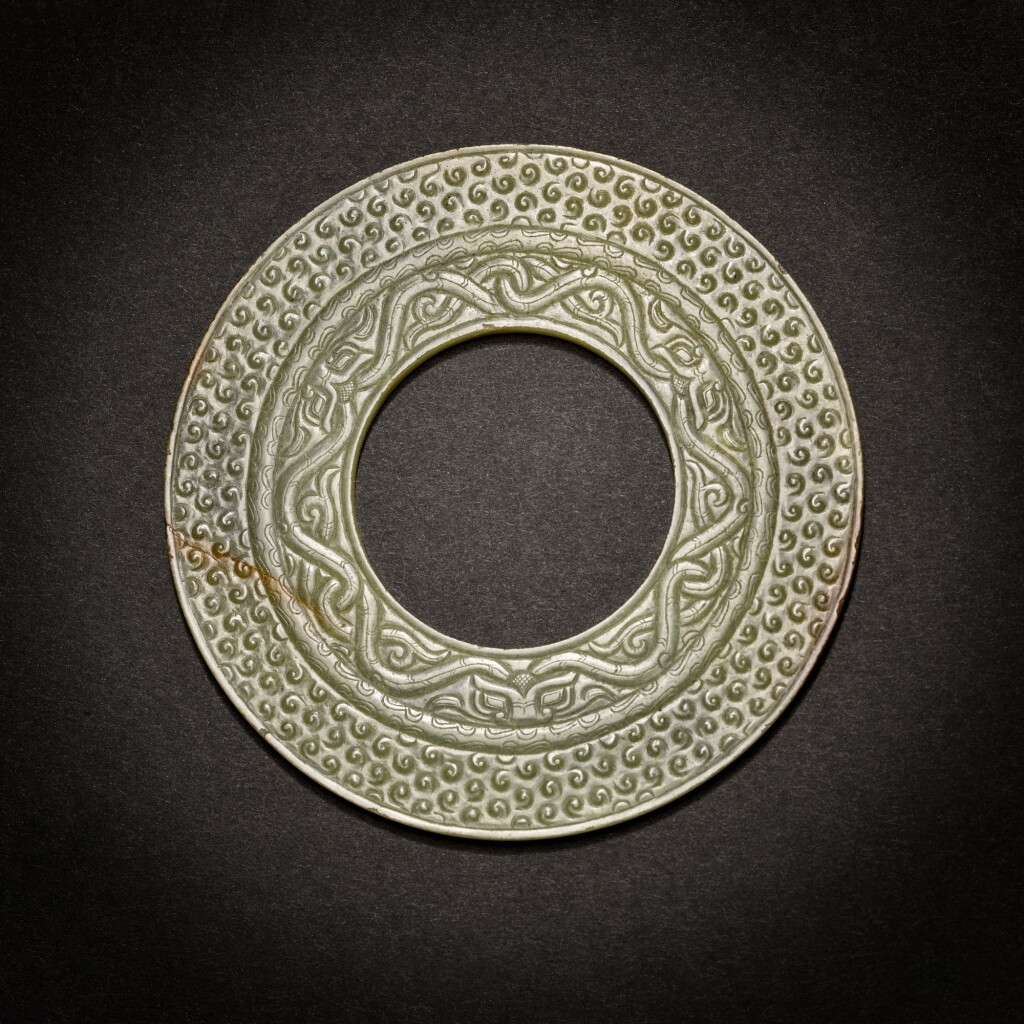 View full screen - View 1 of Lot 5. A green jade disc (Bi), Eastern Zhou dynasty, Warring States period.