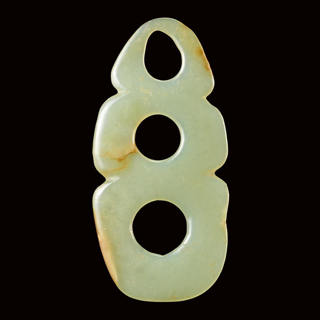View full screen - View 1 of Lot 35. A CELADON JADE THREE-HOLE PLAQUE NEOLITHIC PERIOD, HONGSHAN CULTURE | 新石器時代紅山文化 青白玉三聯璧.
