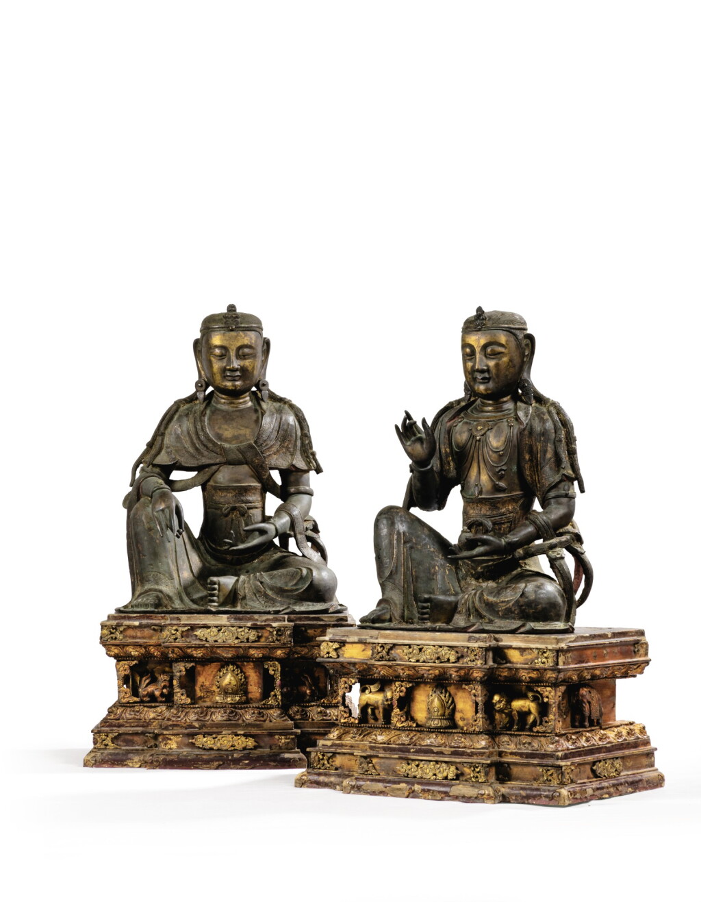 View full screen - View 1 of Lot 14. IMPORTANTE ET TRÈS RARE PAIRE DE STATUETTES DE BODHISATTVA EN BRONZE PARTIELLEMENT DORÉ XIVE SIÈCLE | 十四世紀 鎏金銅菩蕯坐像一對 連 清十八世紀 漆金木雕須彌座一對| An important and very rare pair of parcel-gilt bronze figures of Bodhisattva, 14th century; together with a pair of lacquer-gilt thrones, Qing Dynasty, 18th century.